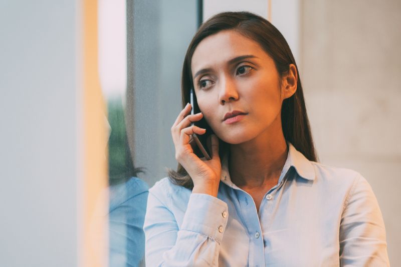 professional woman taking a phone call in her office