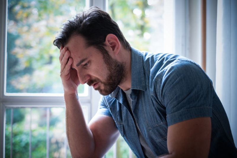 Concerned man with his hand on his head